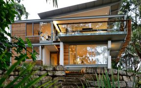 A neat house surrounded by trees that stimulate the emotions of a cheerful beach house using light wood and yellow pops2